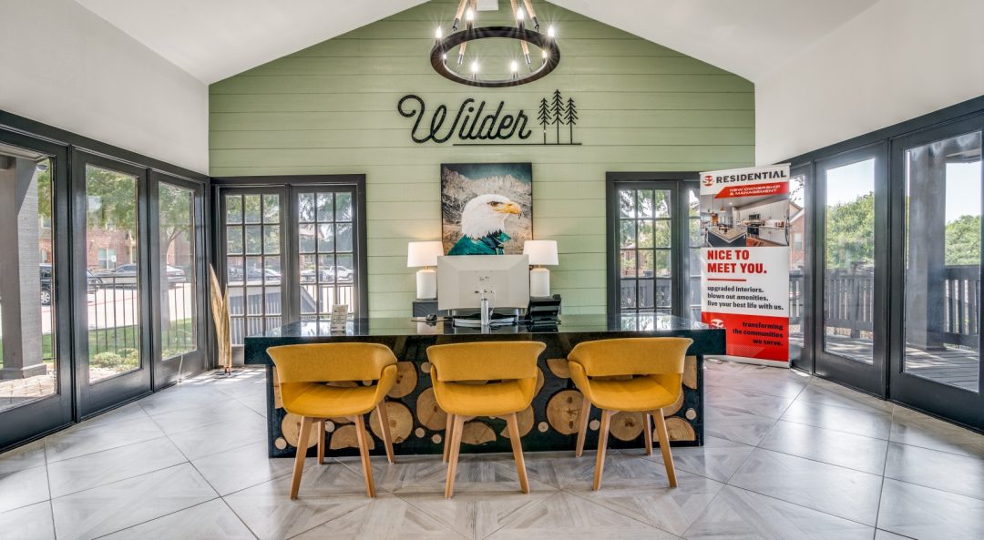 the lobby of a home with a large table and chairs at The Wilder