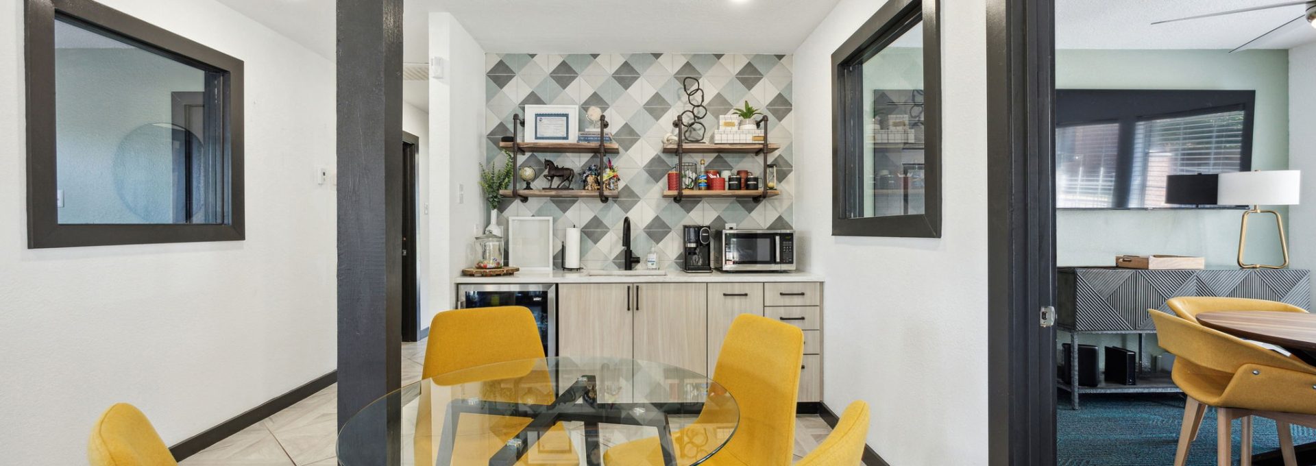 a dining room with yellow chairs and a table at The Wilder