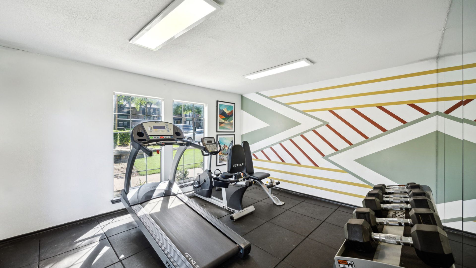 a gym room with treadmills and exercise equipment at The Wilder